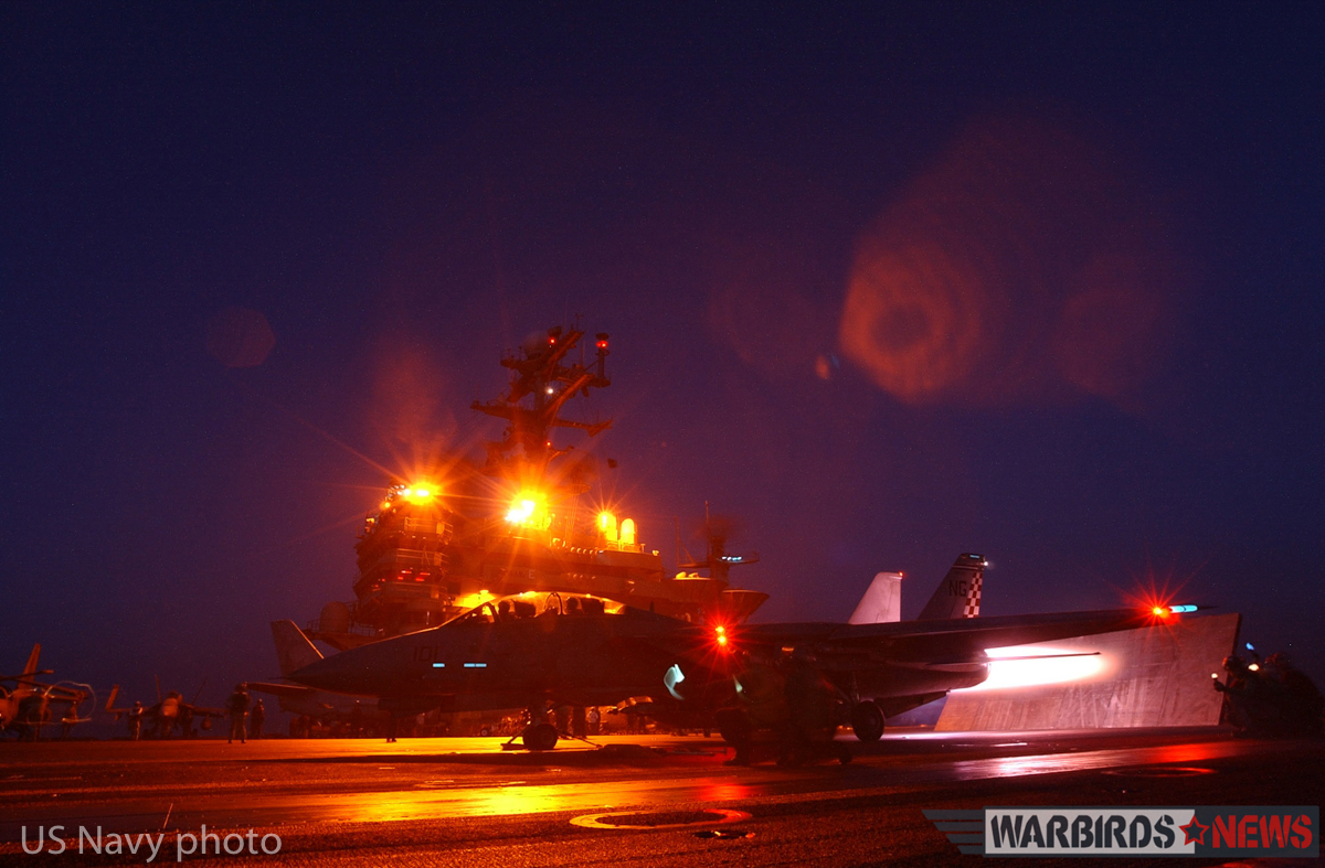 At sea aboard USS John C. Stennis (CVN 74) Jan. 12, 2002 - An F-14 "Tomcat" from the "Checkmates" of Fighter Squadron Two One One (VF-211) ignites its afterburner seconds before a launch from the number three catapult. John C. Stennis and her embarked Carrier Air Wing Nine (CVW-9) continue to conduct bombing missions in support of Operation Enduring Freedom. U.S. Navy photo by Photographer's Mate 3rd Class (AW) Jayme Pastoric (REALEASED)