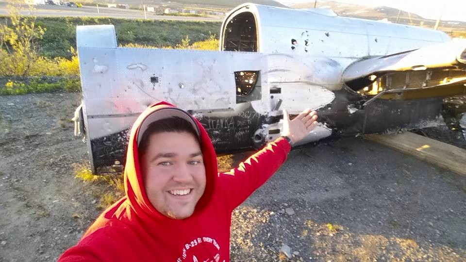 Patrick Mihalek beside the wrecked center section of the Russian B-25 in Nome, Alaska. (photo via Warbirds of Glory)