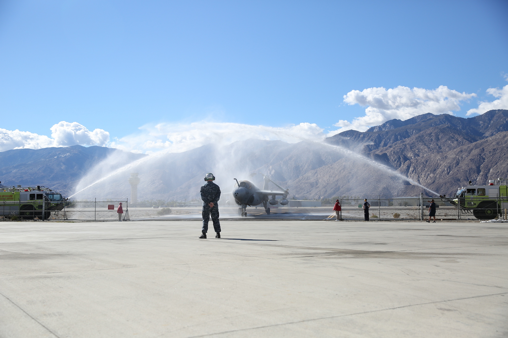 The Navy EA-6B ‘Prowler’ fixed-wing aircraft taxis under a water arch, provided by the Palm Springs Fire Department, during the aircraft’s retirement ceremony at the Palm Springs Air Museum, Nov. 21, 2014. The water arch is a customary farewell for retiring aircraft. (Official Marine Corps Photo by Lance Cpl. Julio McGraw/Released)