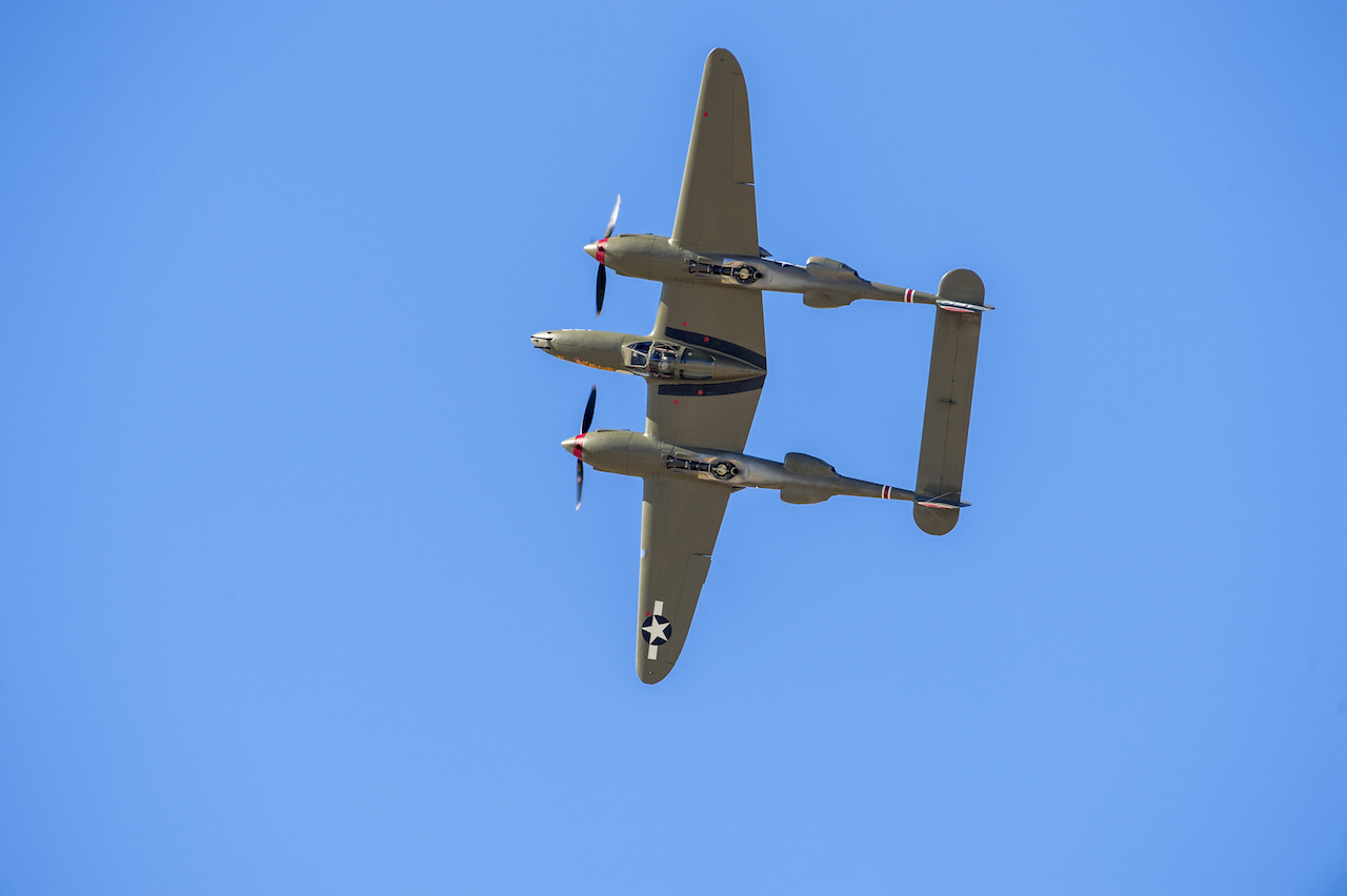 A P-38 Lightning performs a barrel roll at the finale of a formation practice flight during the Heritage Flight Training Course at Davis-Monthan AFB, Tucson, Ariz., Mar 5, 2016. (U.S. Air Force photo by J.M. Eddins Jr.)
