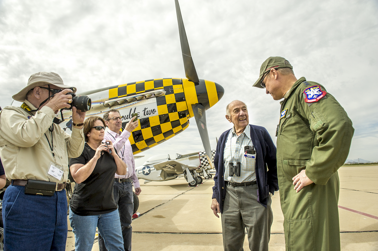 Fred Roberts, 93, second from right, a former P-51D pilot during WWII with the 354th Fighter Squadron, 355th Fighter Group in England, talks with Lt. Gen. Mark C. "Chris" Nowland, Commander, 12th Air Force, Air Combat Command, and Commander, Air Forces Southern, U.S. Southern Command, Davis-Monthan Air Force Base, Ariz. during the Heritage Flight Training Course at Davis-Monthan AFB, Tucson, Ariz., Mar 6, 2016. Roberts was tasked with destroying 57 P-51s after the cease of hostilities in Europe; including one of the planes he flew in combat. (U.S. Air Force photo by J.M. Eddins Jr.)