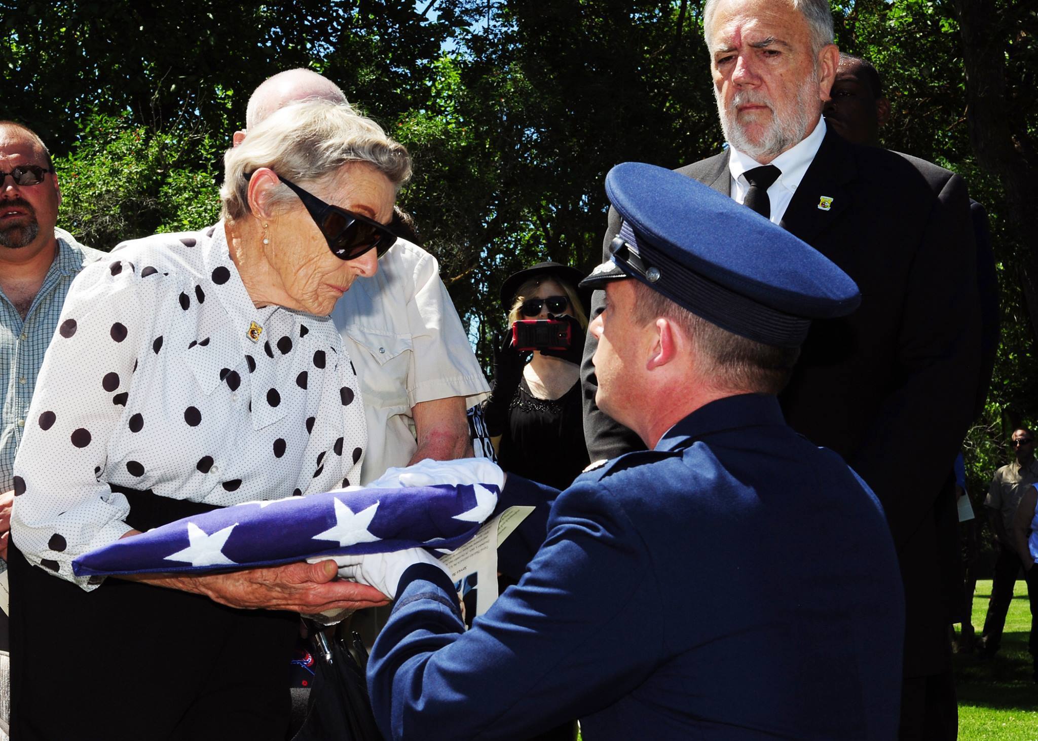 Lt. Col. Michael Epper, 341st Force Support Squadron commander, presents the flag to Dawn Thatcher, wife of Staff Sgt. David J. Thatcher, during a funeral service June 27 in Missoula, Mont. At 20 years old, Sgt. Thatcher was an engineer gunner in Flight Crew 7 of the Doolittle Tokyo Raids. His crew crash-landed into sea off the coast of China on April 18, 1942. Thatcher saved four members of the crew by pulling them to safety on the surrounding beach and applying life-saving medical treatment, even though he was injured himself. (U.S. Air Force photo by 2nd Lt. Annabel Monroe) 