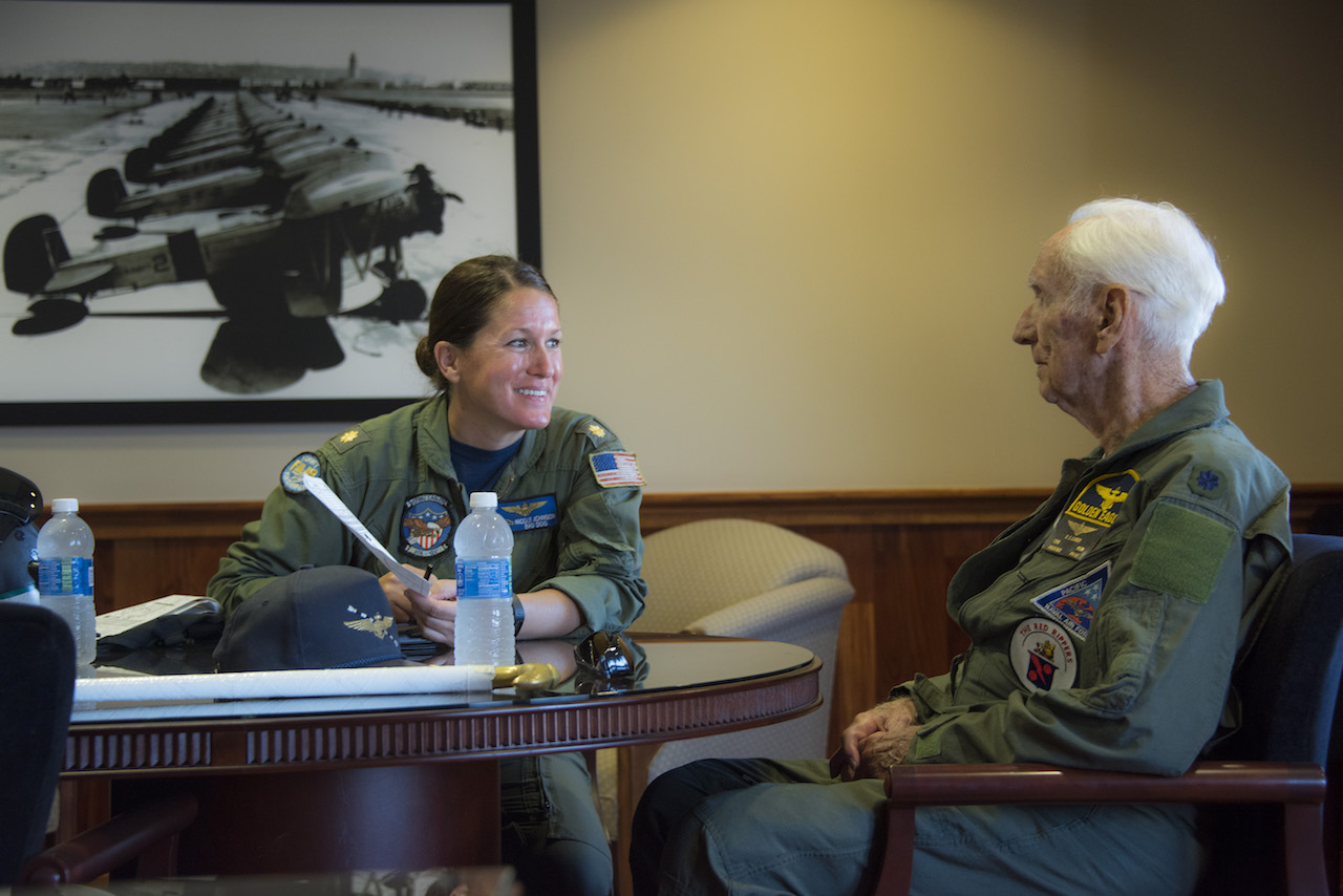 Retired Cmdr. Dean "Diz" Laird, right, and Lt. Cmdr. Nicole Johnson, a pilot instructor with the "Flying Eagles" of Strike Fighter Squadron (VFA) 122, conduct a flight brief for a T-34C Turbomentor. The T-34C marks the 100th aircraft Laird has flown in his 95-year lifetime. (U.S. Navy photo by Mass Communication Specialist 2nd Class Paolo Bayas/Released)
