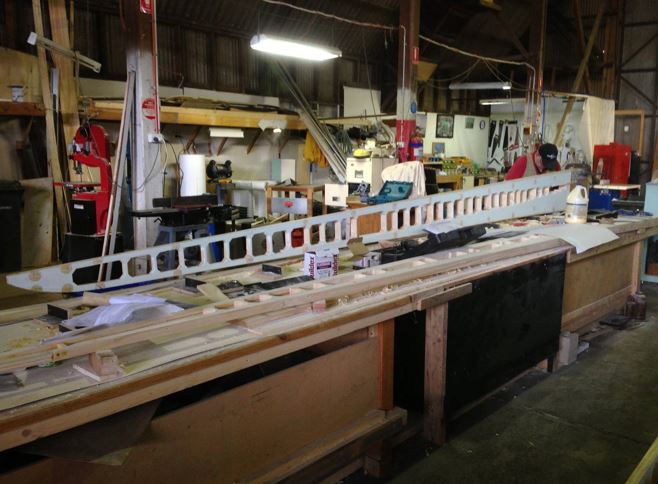 A wing main spar takes shape on the work bench. (photo via B-24 Liberator Memorial Fund)