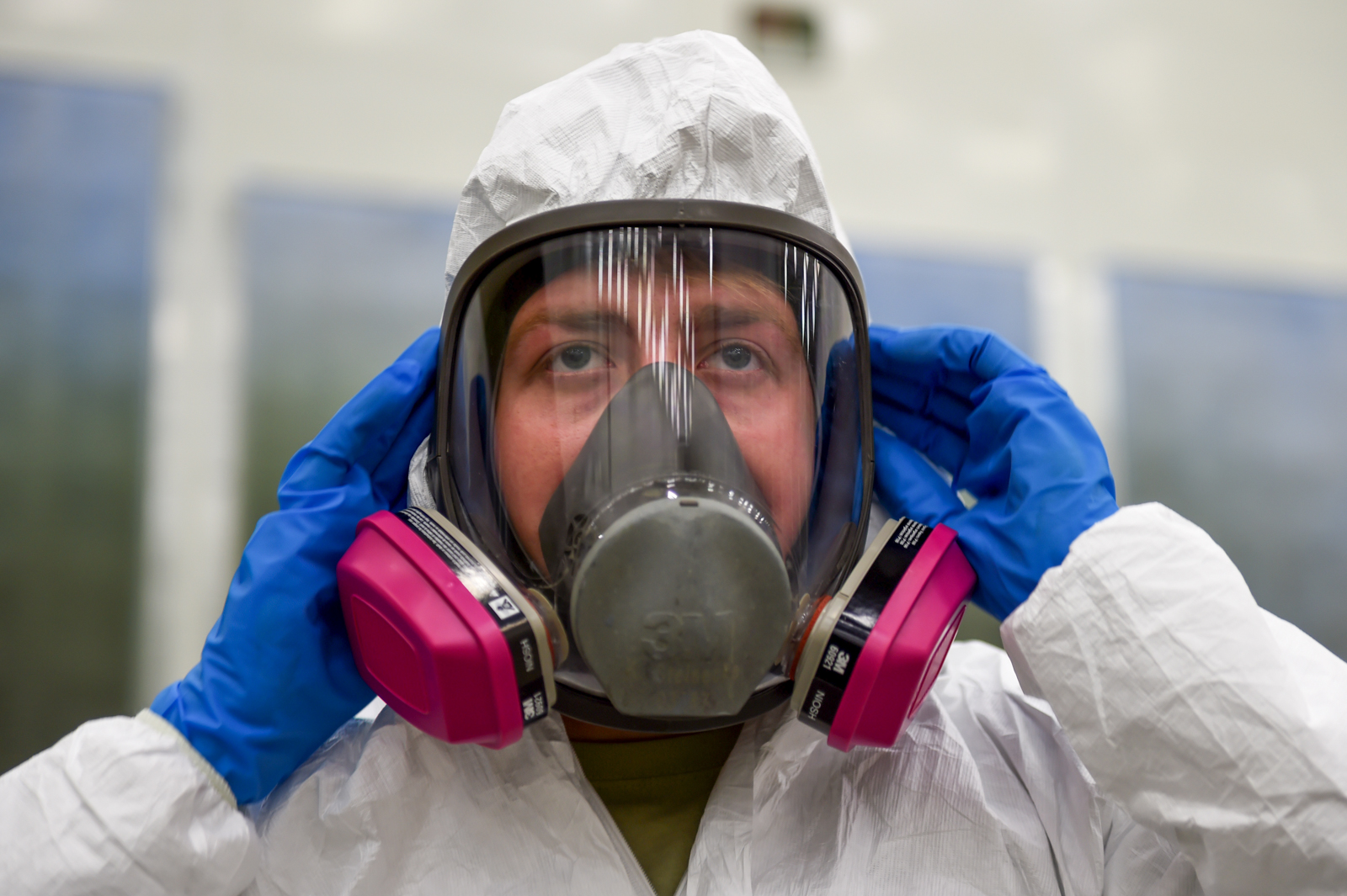 Air Force Senior Airman Kurtis Steinecke dons a Tyvek suit and full-face respirator before painting the P-38G Lightning inside Hangar 21 at Joint Base Elmendorf-Richardson, Alaska, July 17, 2017. Airmen are required to wear personal protective equipment when working on the P-38G Lightning. Steinecke is assigned to the 3rd Maintenance Squadron as an aircraft structural maintenance journeyman. (U.S. Air Force photo by Staff Sgt. Sheila deVera)