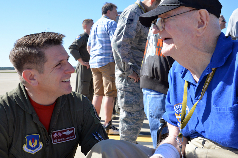 U.S. Air Force Col. Christopher Amrhein, 100th Air Refueling Wing commander, speaks to Frank "Bud" Buschmeier during the opening event of the 100th Bomb Group Foundation reunion at Washington Dulles International Airport, Va., Oct. 19, 2017. Buschmeier is a World War II veteran who flew on 34 missions over Europe. (U.S. Air Force photo/Tech. Sgt. David Dobrydney)
