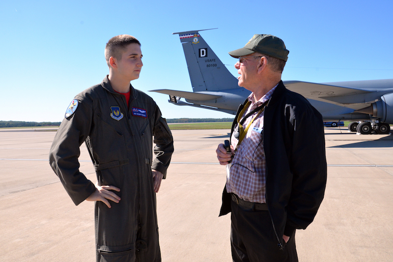U.S. Air Force Airman 1st Class Derek Piefer, 351st Air Refueling Squadron boom operator, talks with Ron Batley during the opening event of the 100th Bomb Group Foundation reunion at Washington Dulles International Airport, Va., Oct. 19, 2017. The event featured a static display of a B-17 Flying Fortress and KC-135 Stratotanker. Batley is the curator of the 100th Bomb Group Memorial Museum in England. (U.S. Air Force photo/Tech. Sgt. David Dobrydney)
