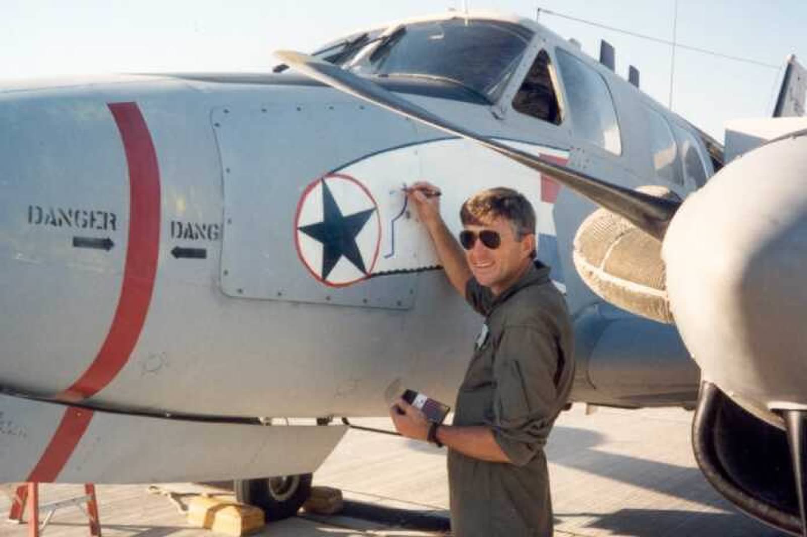 One of the 1990 aircrew painting on the nose art prior to the aircraft's ferry flight to Saudi Arabia for Operation Desert Storm. (photo via Andrew Rodriguez)
