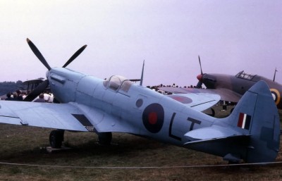 Supermarine Spitfire Reconnaissance model with a fighter model in background, showing differences in color scheme and canopies.