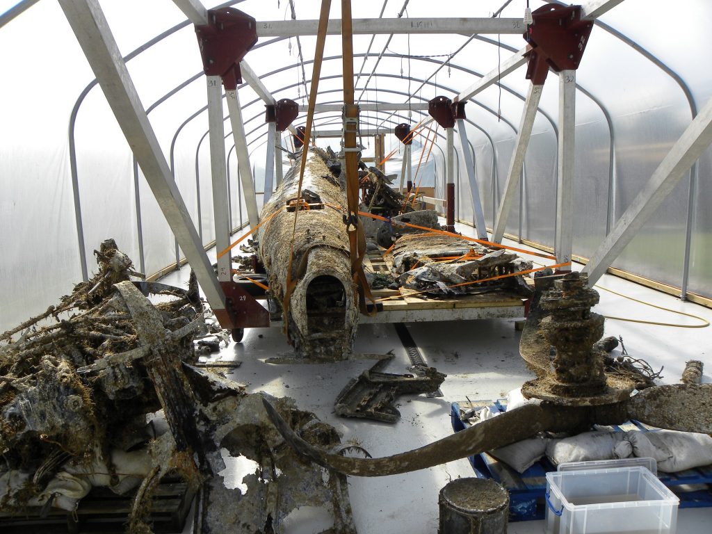 The larger pieces of the the Dornier Do 17 still receiving their citric acid soak in the specially-constructed hydration tunnels. (Image Credit: RAF Museum)