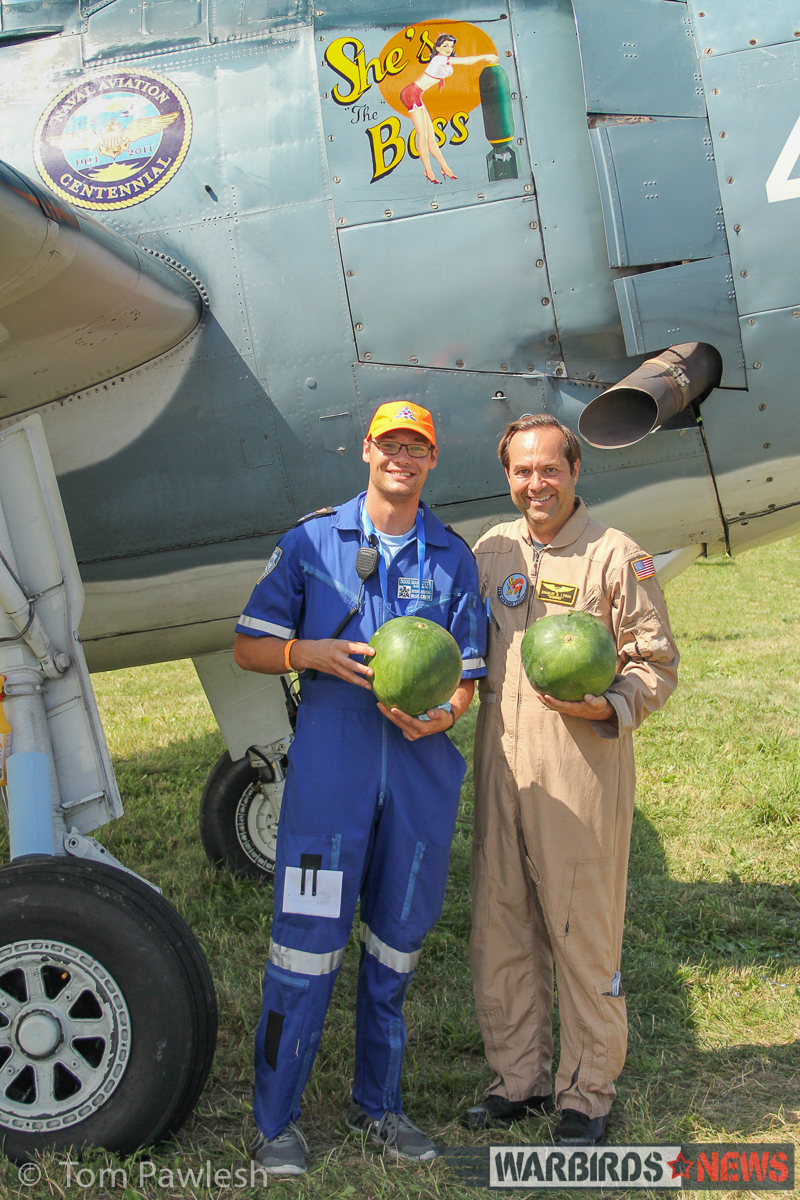Charlie Lynch (r) in front of his TBM with Doug Marotte, showing off a pair of watermelons which would be used in the watermelon 'bomb' drop flown by Lynch in his TBM. (Photo by Tom Pawlesh)