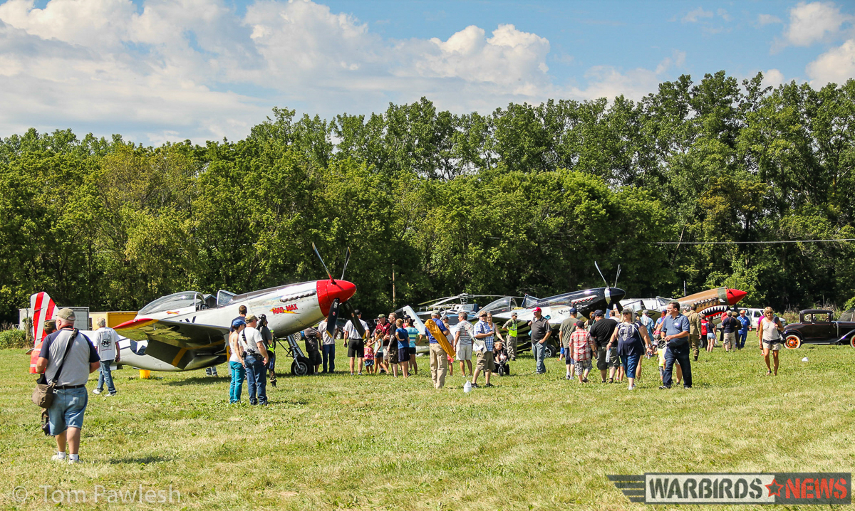 The crowd getting an up-close look at some of the warbirds on display. Nothing beats a grass airfield for showing off WWII aircraft! (Photo by Tom Pawlesh)