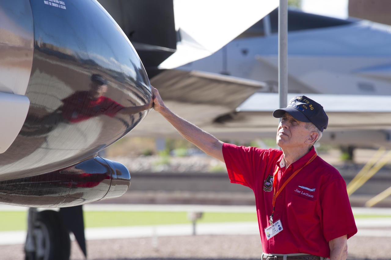 Col. (Ret.) Joe Latham, previously an F-4 Phantom pilot from Holloman Air Force Base, N.M., stops Sept. 13, 2016, to reminisce next to the F-4 adorned with his name Sept. 13, 2016, at Holloman AFB’s Heritage Park. Latham’s visit was part of Holloman’s annual Phantom Society Tour where 160 aircraft enthusiasts, including veterans and non-veterans with aviation backgrounds, visit various base locations. The tour included an F-16 Fighting Falcon briefing and static display, travel to Holloman’s High Speed Test Track, the opportunity to view QF-4s and F-16s in flight, and a visit to Heritage Park to view displays of various aircraft historically stationed at Holloman AFB. (U.S. Air Force photo by Master Sgt. Matthew McGovern)