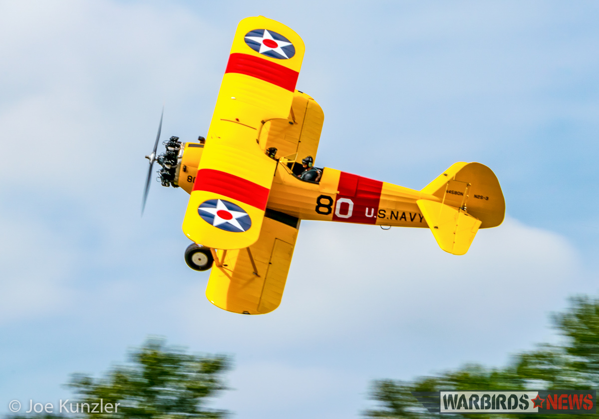 Alex Bock's N2S-3 Stearman doing a 'Banana Pass' to show off her top side to the crowd. (photo by Joe Kunzler)