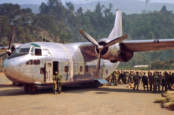 An-Air-America-C-123-delivering-supplies-and-picking-up-Laotian-troops-at-Long-Tieng.-RLW-585x388