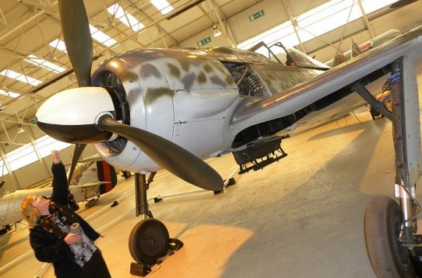 The RAF museum's assistant curator with he FW-190. Image credit '©Trustees of the Royal Air Force Museum’