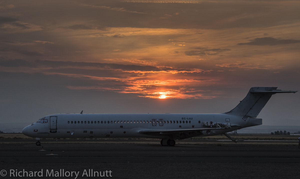 The sun sets, bringing one of Ericsson's MD-87's into silhouette. There are five examples on site awaiting their conversion into fire bombers. Several operational examples are currently in Montana fighting fires right now. (photo by Richard Mallory Allnutt)