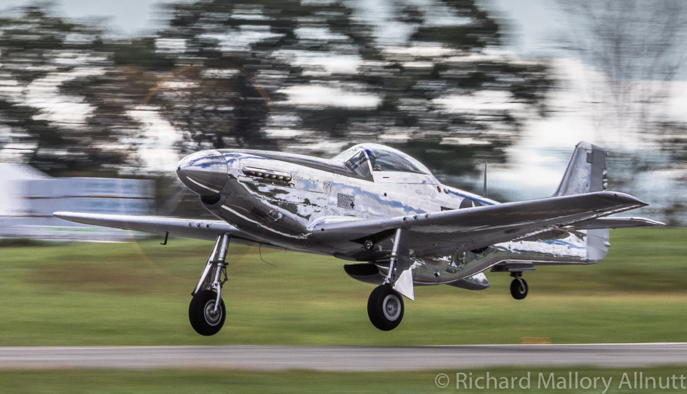 Major General Tommy Williams lifts off in Andrew McKenna's magnificent P-51D Mustang to perform a faultless aerobatics routine. (photo by Richard Mallory Allnutt)