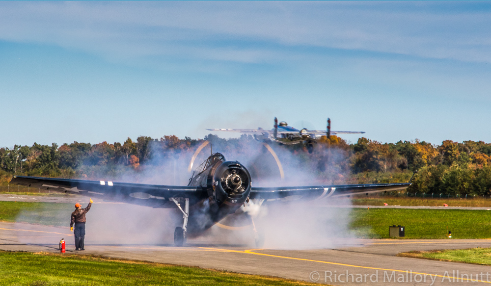 Panchito lifts into the autumn skies as the locally based CAF National Capitol Squadron's TBM starts up in a cloud of smoke. (photo by Richard Mallory Allnutt)