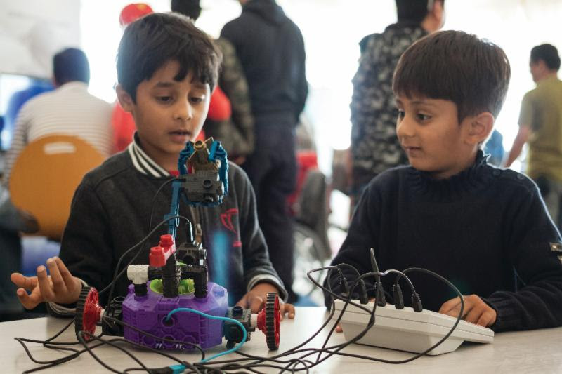 Boys build their own robot during a workshop at The Museum of Flight. Photo Ted Huetter/The Museum of Flight. 