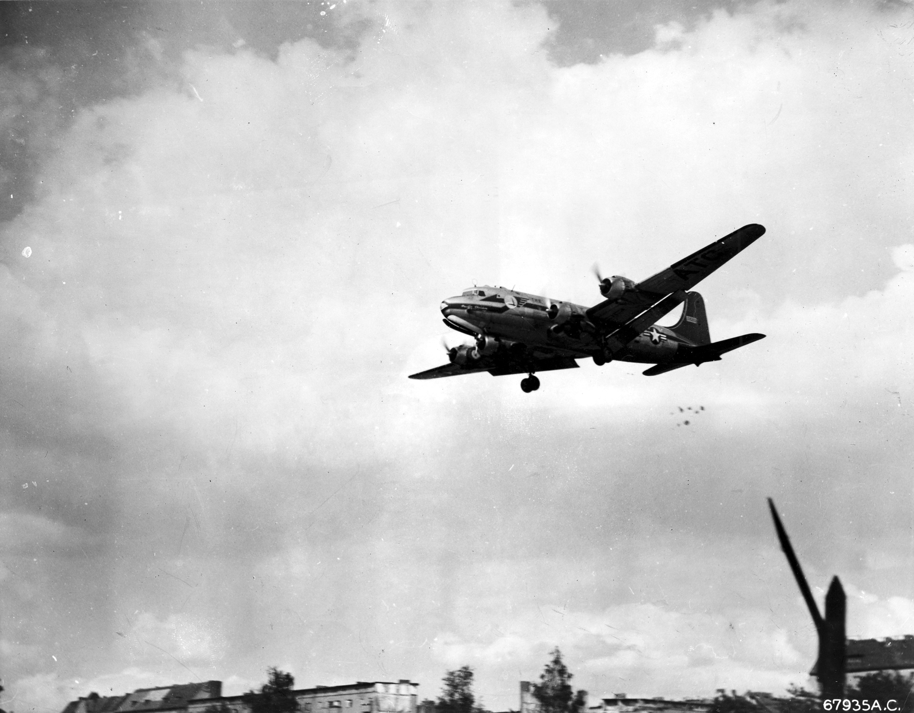 A "Little Vittles" candy drop. Note the parachutes below the tail of the C-54. (U.S. Air Force photo)