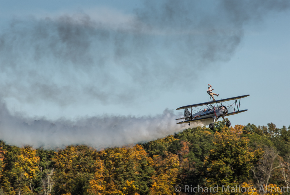 Pulling the Stearman down low along the runway with the fall colors sparkling on the trees behind. (photo by Richard Mallory Allnutt)