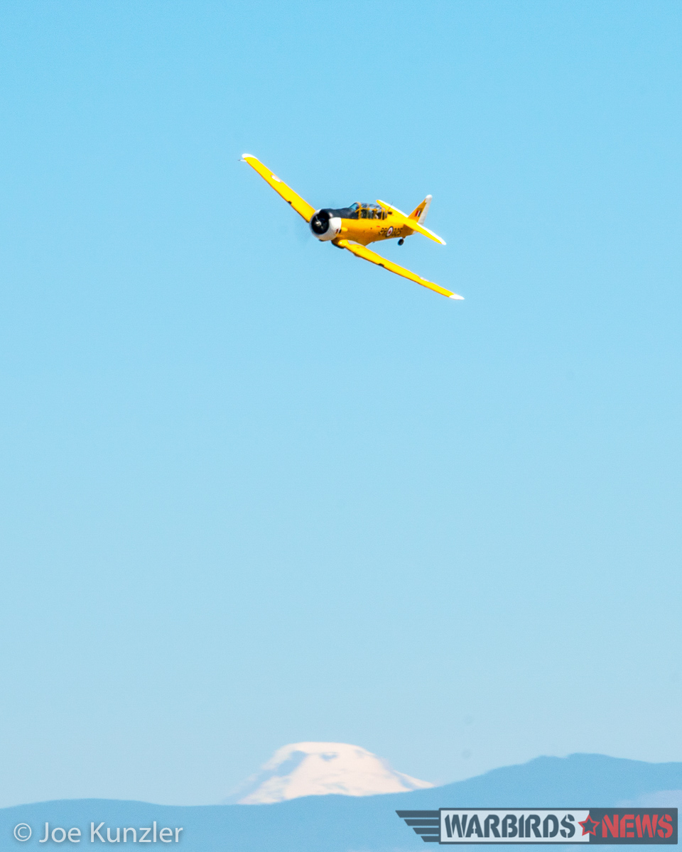 A Canadian Harvard banking with Mt. Baker in the background, just before roaring down the runway on a low approach. (photo by Joe Kunzler)