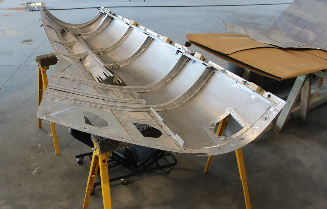 An interior view of the top right cowl for the right-hand engine during the tack-riveting process. Clecos are holding the ribs in place at this point. (photo via Tom Reilly)