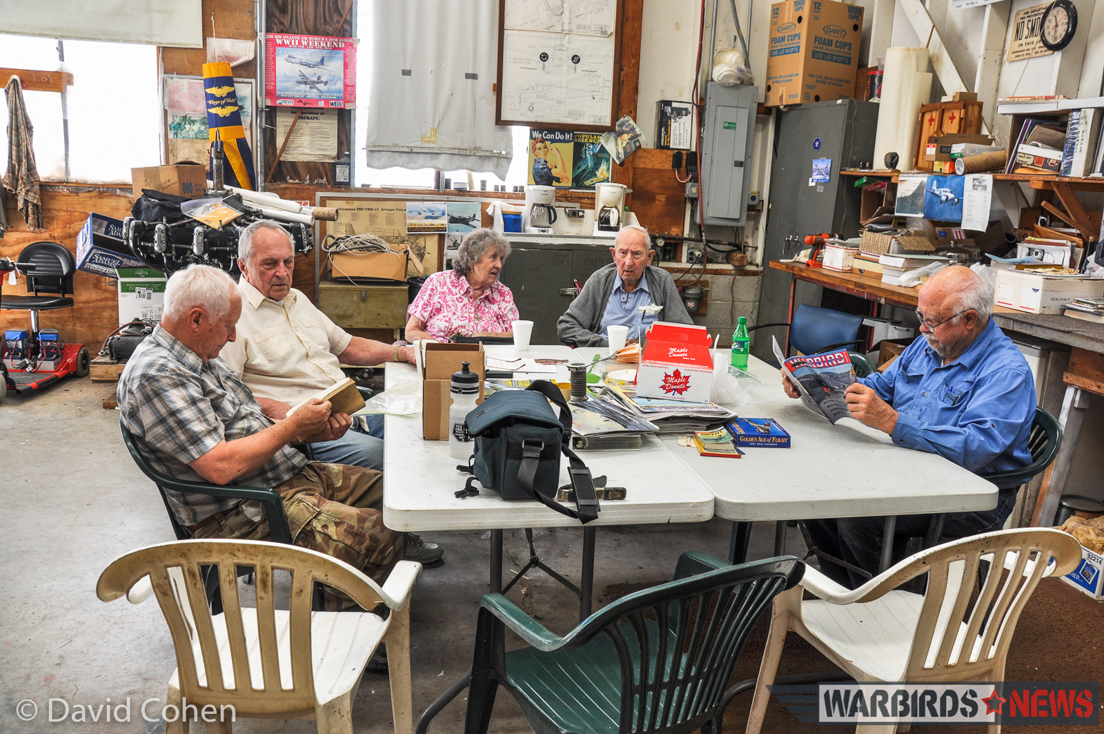 Some of the team at rest. At the table, left to right - Barry Stump, Dick Santora, Ruby Kosko, Jack Kosko and Gene Ambrose (notice Gene is reading Warbird Digest). (Photo by David Cohen)
