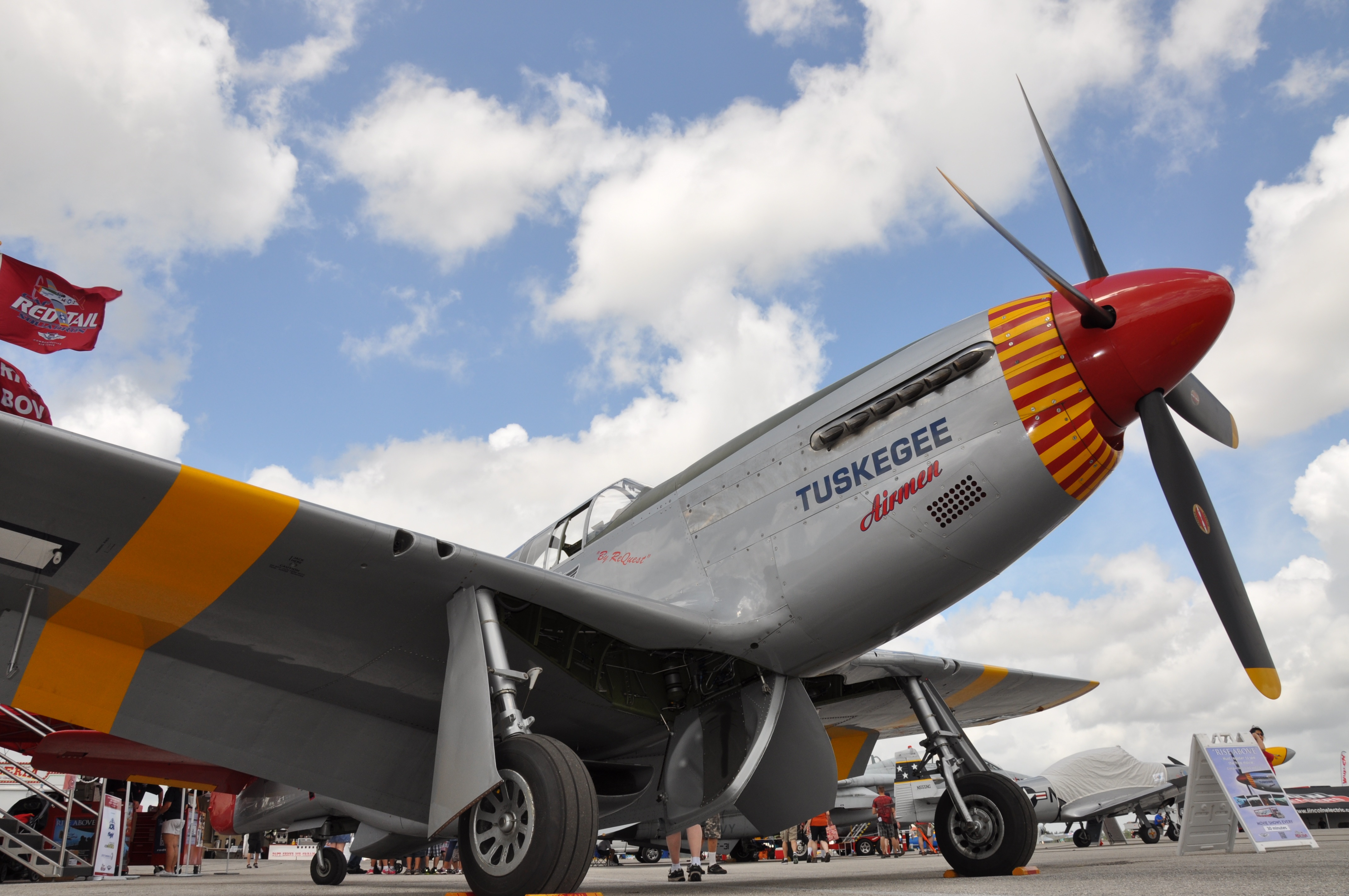 Red Tail Squadron’s Mobile Exhibit honoring the Tuskegee Airmen opens inside the Hangar on Friday. This is fully expandable, movie theater with 30 seats, air conditioned, that shows a 30 min documentary on the Tuskegee, “Rise Above.”I Image by Warbirds News)