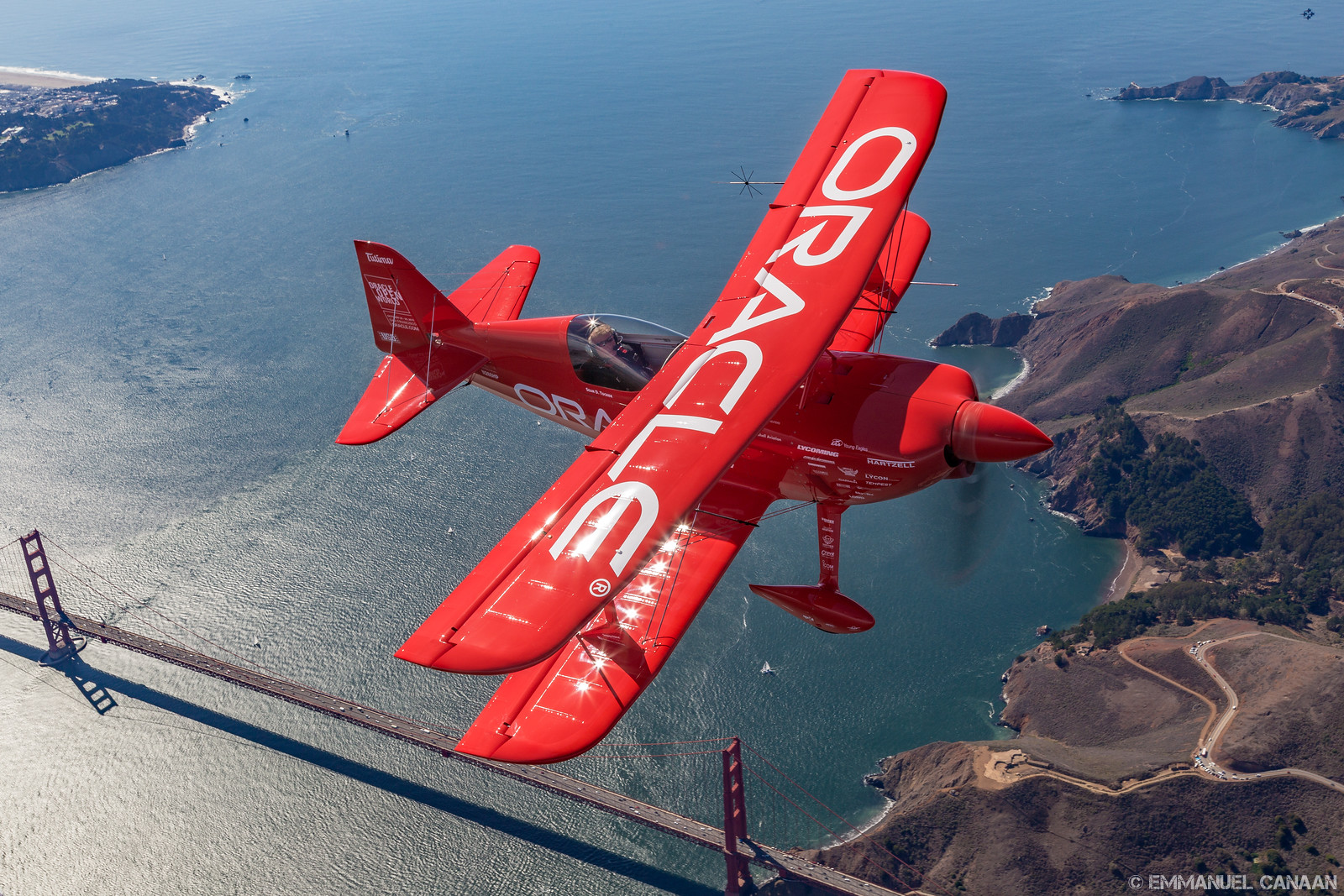 Sean D. Tucker cruises over the Golden Gate Bridge as he awaits the U.S. Navy Blue Angels during San Francisco's 2015 Fleet Week air show. You can just see a Blue Angels four-ship way in the background of the top right corner. (photo by Emmanuel Canaan)