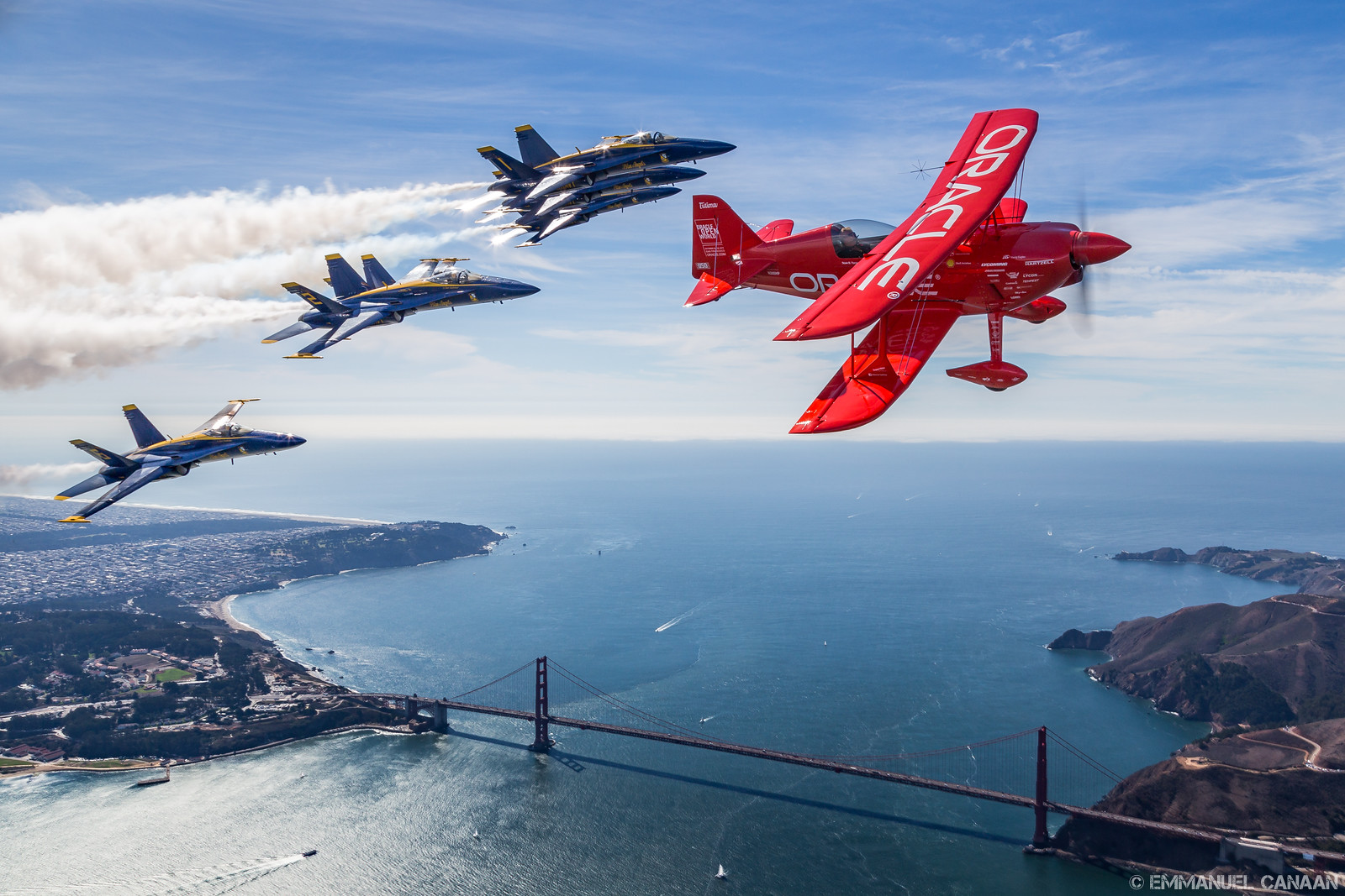 Sean D. Tucker and the U.S. Navy Blue Angels soar high above the Golden Gate Bridge in San Francisco, California during Fleet Week 2015. (photo by Emmanuel Canaan)