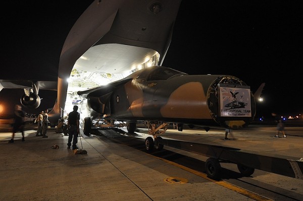 RAAF F-111C gets offloaded from an RAAF Boeing C-17 Globemaster in Hawaii. (Image Credit: Pacific Aviation Museum)