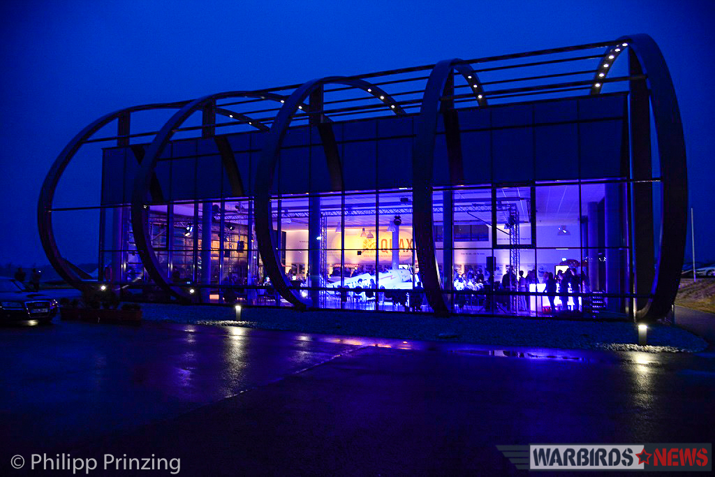 A view of Quax's fantastic hangar at night, showing their new prize illuminated within. (photo by Philipp Prinzing)