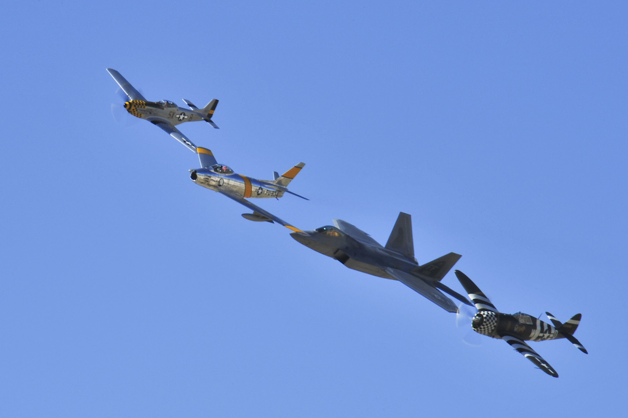 A P-51 Mustang, F-86 Sabre, F-22 Raptor and P-47 Thunderbolt fly in formation during the 2015 Heritage Flight Training and Certification Course at Davis-Monthan Air Force Base, Ariz., Feb. 26, 2015. The annual aerial demonstration training event has been held at D-M since 2001, providing civilian and military pilots the opportunity to practice flying in formation for the upcoming air show season. (U.S. Air Force photo by Airman 1st Class Chris Massey/Released)