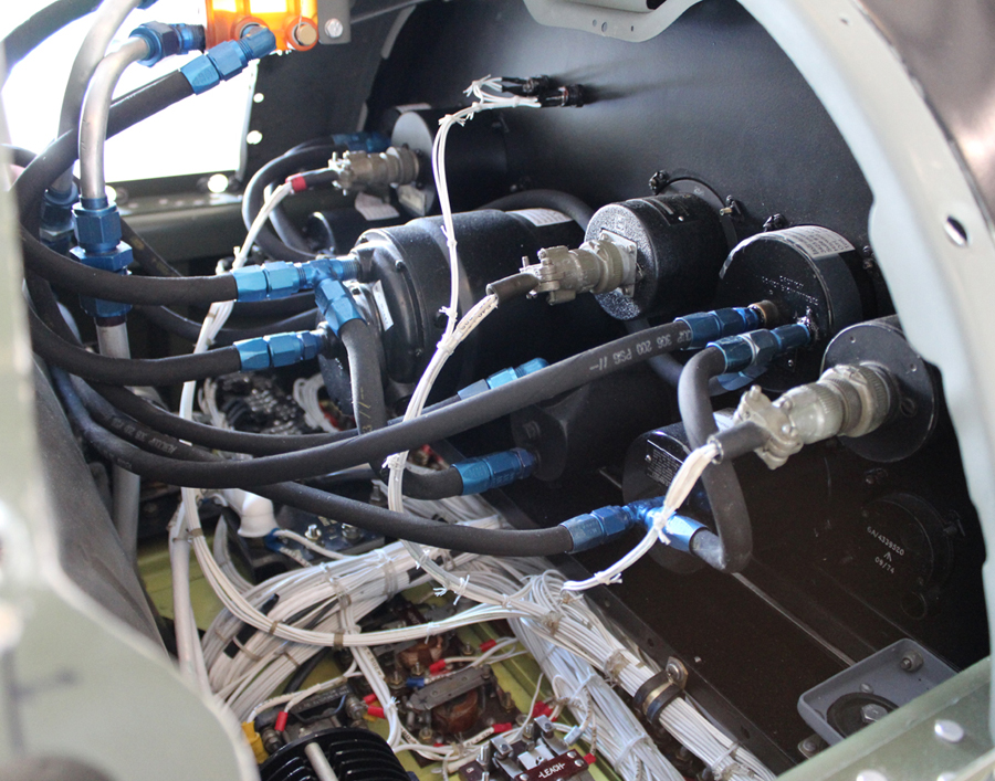 Hoses and wiring behind the co-pilot's instrument panel. (photo via Tom Reilly) 