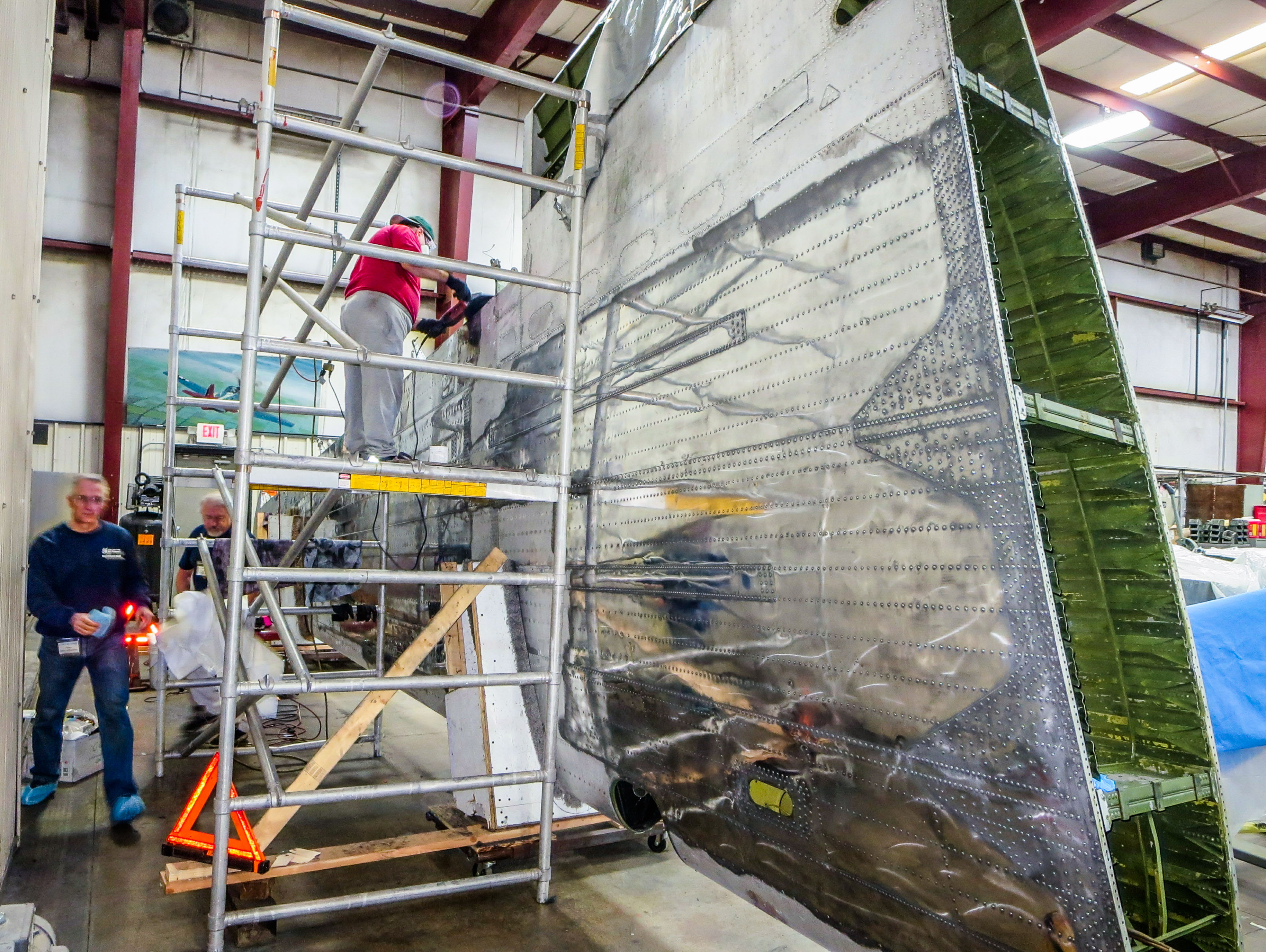 Members of the restoration team soon got to work polishing the left wing. (photo via NEAM)