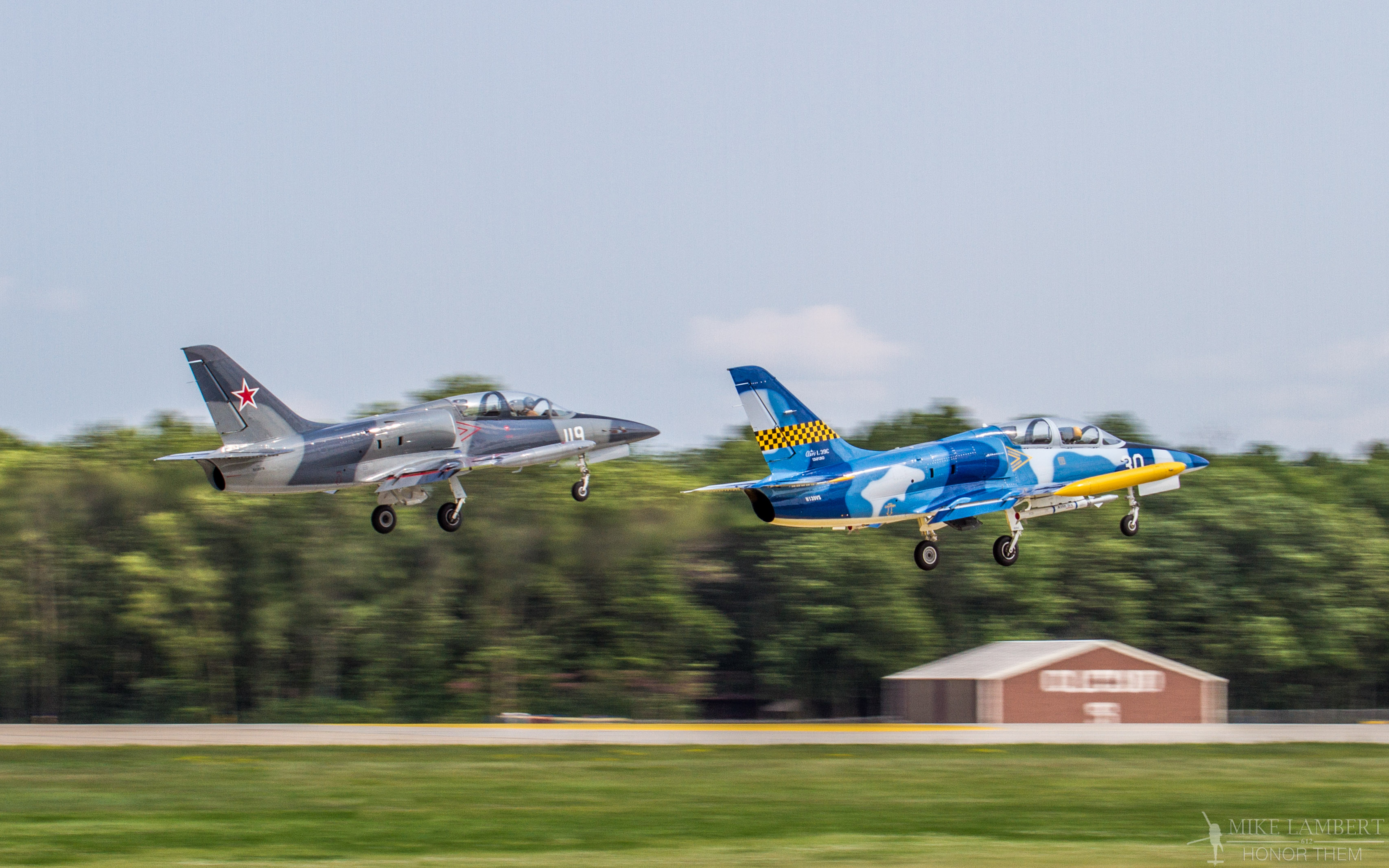 Ron Staley's L-39 (Blue/Yellow) is number taking off for a show at Oshkosh, WI.