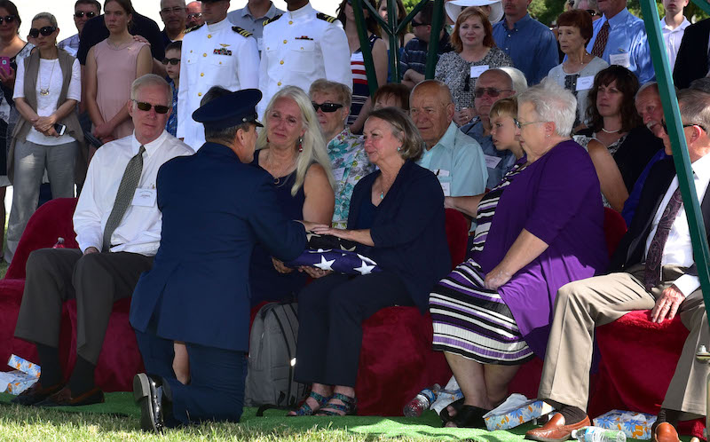 Lynn Evans, niece of John Dean Armstrong, a Flying Tiger, is presented a flag during Armstrong’s funeral, June 17, 2017, in Hutchinson, Kan