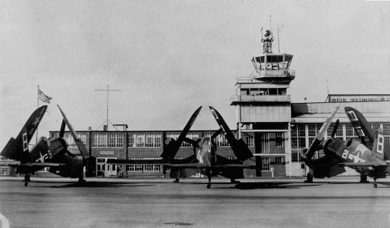 Corsairs lined up in front the old control tower and what is now the Downwind Restaurant.
