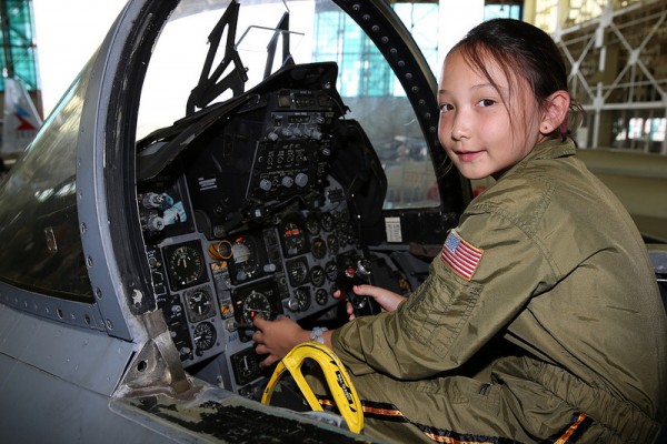 A your girl enjoying the excitement of "flying" a jet.(Image credit Pacific Aviation Museum)