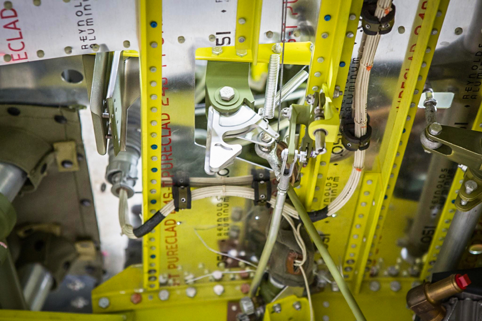 The hook-like part is the main gear uplock latch. (photo via AirCorps Aviation)
