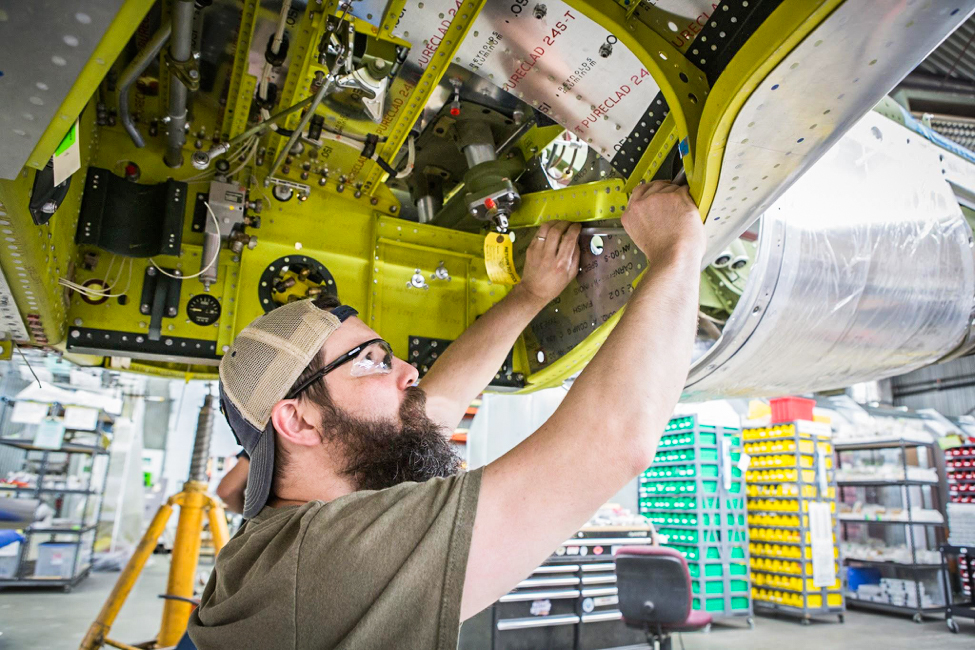 Randy installs a drop tank pressurization line. (photo via AirCorps Aviation)