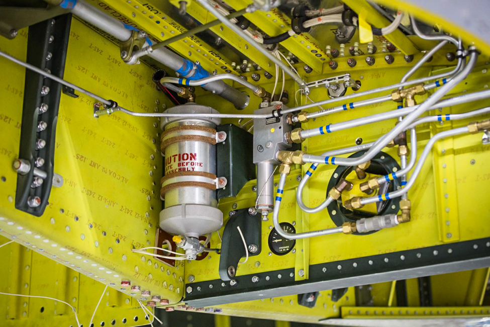 The hydraulic accumulator stores pressurized hydraulic fluid for the retract system. (photo via AirCorps Aviation)