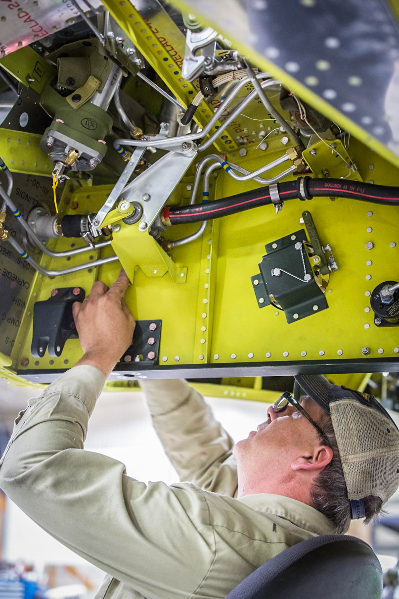 Robb is installing the bracket for the fuel shut off linkage. (photo via AirCorps Aviation)
