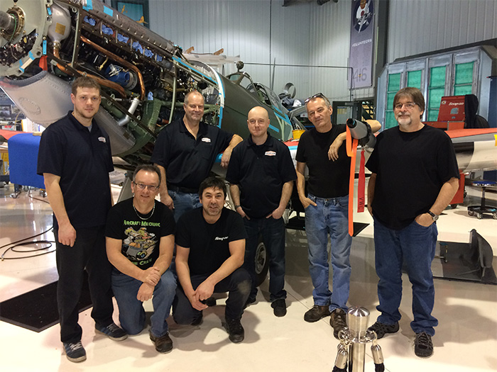 It takes a village to raise a Spitfire. Some of the mechanics involved today with the Roseland Spitfire project: (standing left to right): Pat Tenger, Ken Wood, Mark Dufresne, Gerry Bettridge. At right is Mike Irving, who has just joined Vintech Aero. Taking a knee: André Laviolette and Paul Tremblay. (Photo: by Dave O'Malley)