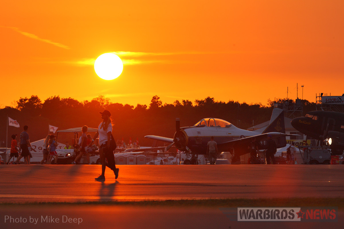 The sun sets on the Warbird Ramp Wednesday. Earlier that evening, the Mustangs gathered here were whisked away to shelter in anticipation of an approaching storm front. 