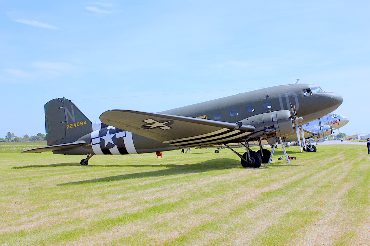 Formerly "The Union Jack Dak" when it appeared at the Oshkosh 75th anniversary Dak-Meet in 2010, N74589/224064 is a C-47A c/n 9926 built at Long Beach and restored by Clive Edwards and co from the UK in Covington, Georgia in 2010. It was re-painted in these D-Day colours in 2011. It was flown to the UK from the USA in early May and transited from Goose Bay to Narsarsuaq on 8th and then on to Reykjavik. It has been based at Waterbury/Oxford in Connecticut, but may stay on in the UK after the D-Day celebrations as its owner is British. It was one of two Daks that attended from the USA, the other from the National Warplane Museum at Geneseo, NY. Photo by Geoff Jones