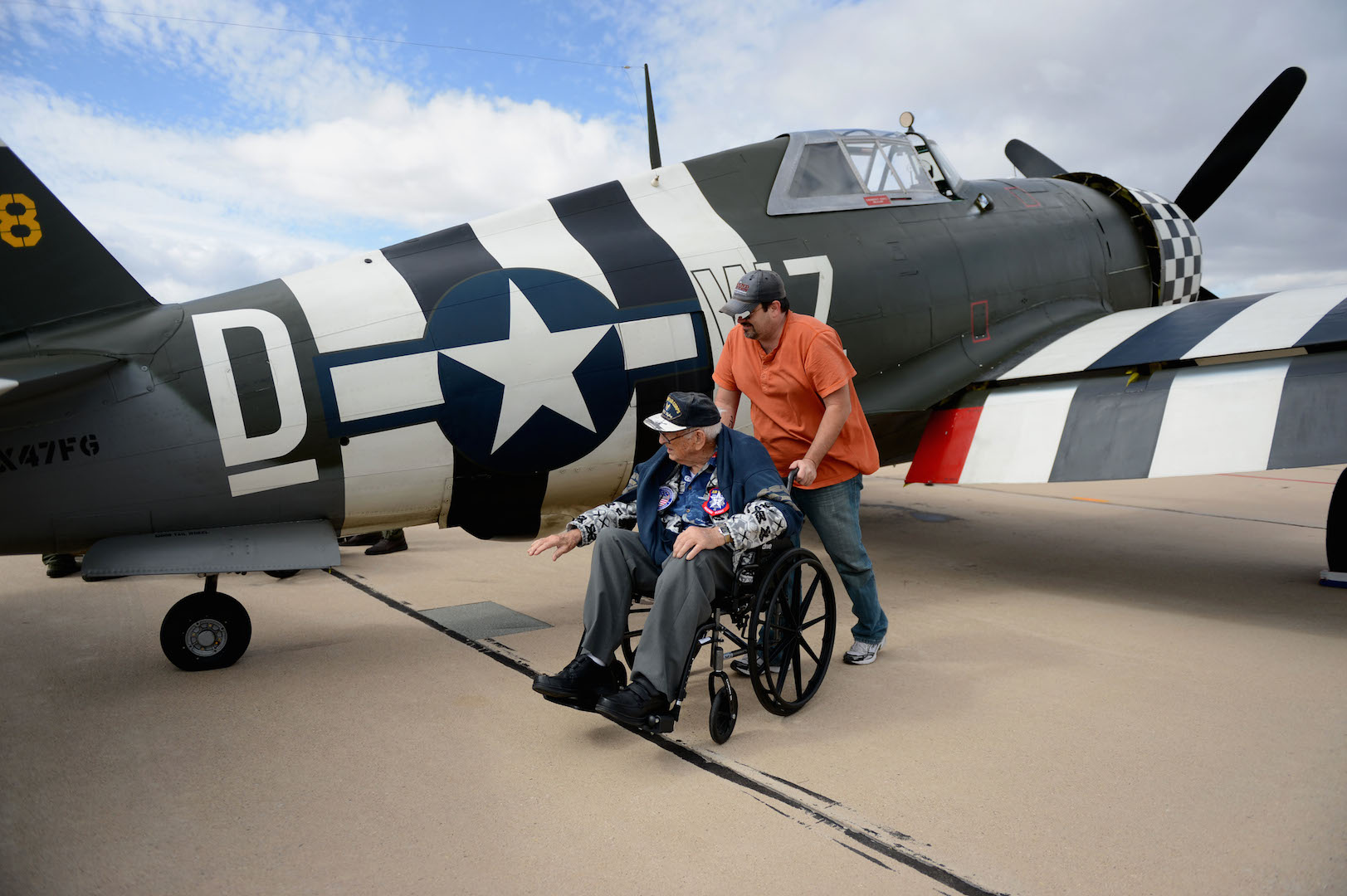 Retired Air National Guard Chief Warrant Officer 2 Robert Hertel touches a P-47 Thunderbolt, for the first time since the 1960's, during the Heritage Flight Training and Certification Course Feb. 28, 2015, at Davis-Monthan Air Force Base, Ariz. Hertel was given the opportunity to visit the aircraft as well as received praise from Gen. Hawk Carlisle, Commander of Air Combat Command, for his contributions to America. (U.S. Air Force photo/Senior Airman Jensen Stidham)