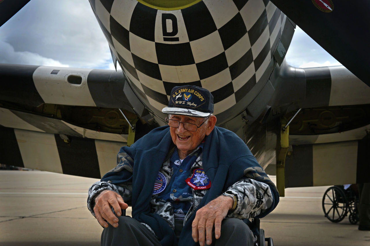 Retired Air National Guard Chief Warrant Officer 2 Robert Hertel, laughs while sitting in front of a P-47 Thunderbolt during the Heritage Flight Training and Certification Course Feb. 28, 2015, at Davis-Monthan Air Force Base, Ariz. Hertel, a 92-year-old World War II veteran, flew the aircraft while stationed in Iwo Jima, Japan. (U.S. Air Force photo/Senior Airman Jensen Stidham)